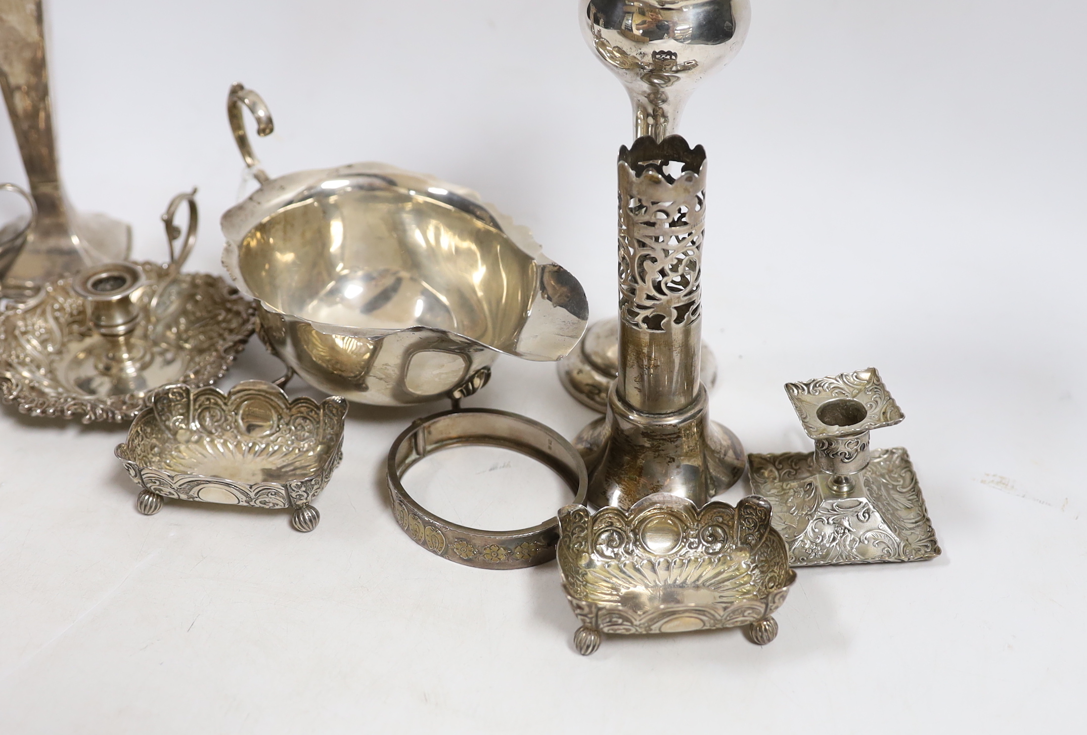 Sundry small silver including a sauceboat, two mounted posy vases, pair of salts, small cream jug, mounted vase section, chamberstick and a hinged bracelet, together with a small 800 standard chamberstick.